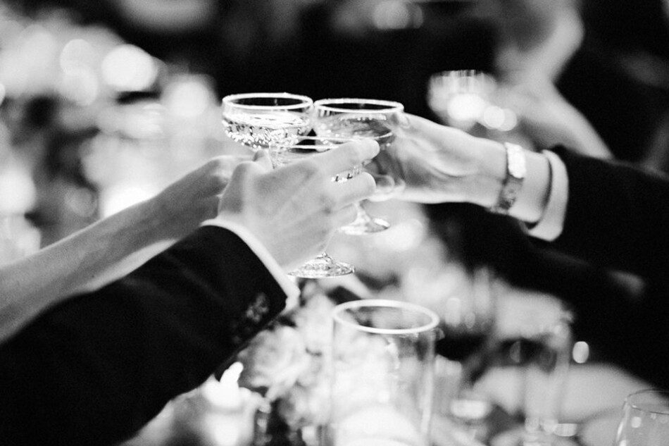 Wedding guests toasting couple